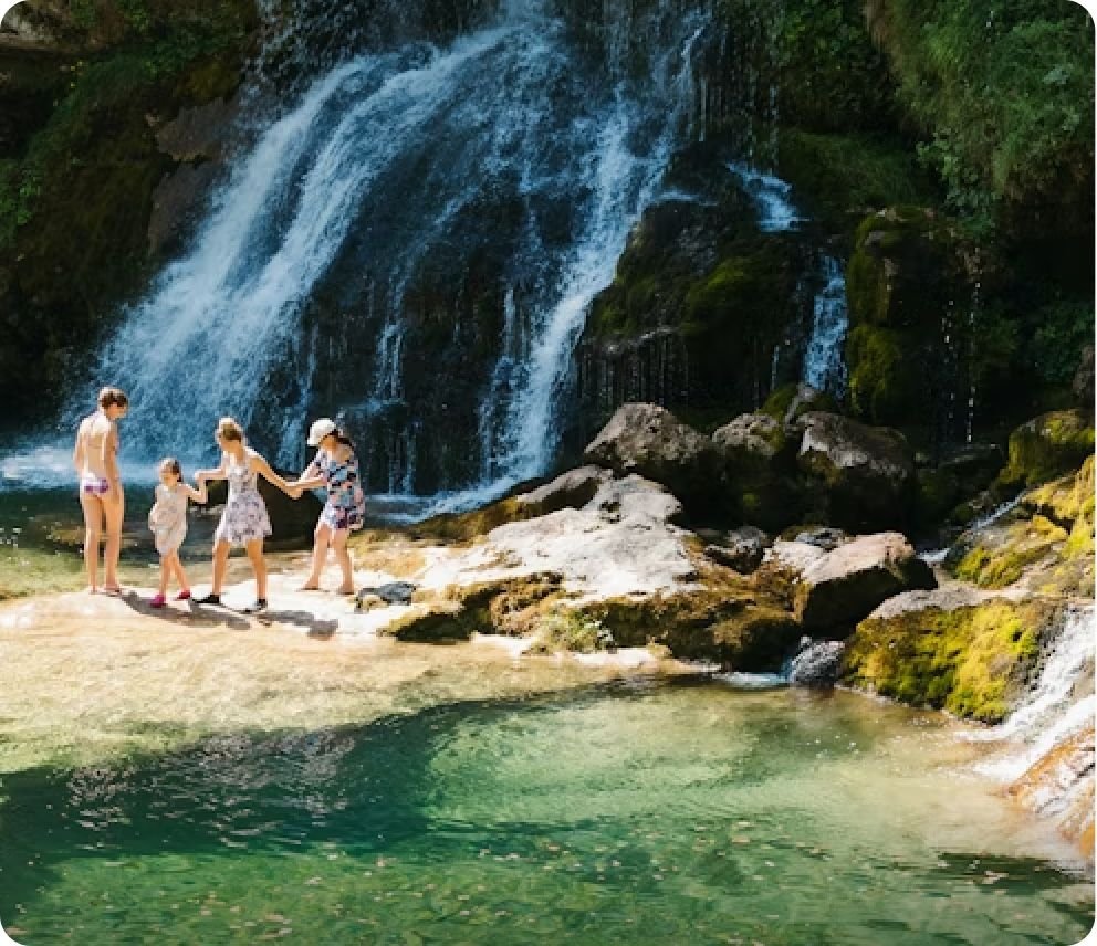 People relaxing by a waterfall, representing a lighter footprint